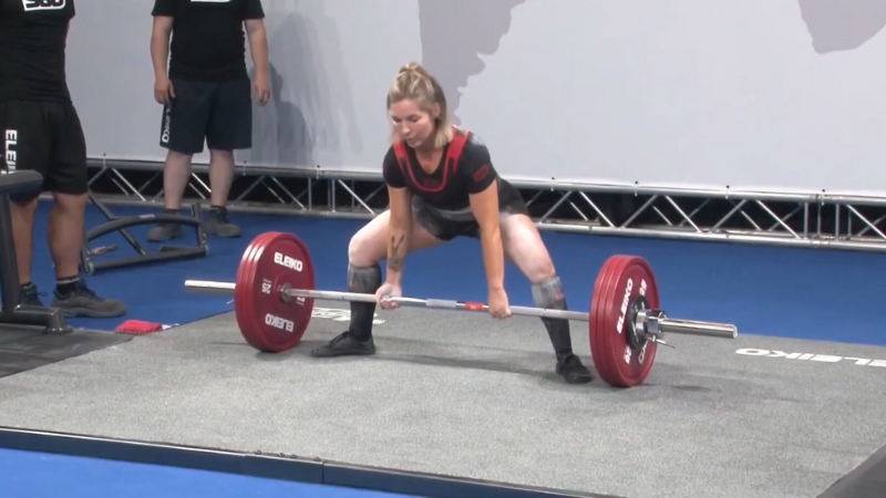 Elizabeth Craven prepares to lift a loaded barbell during a powerlifting competition
