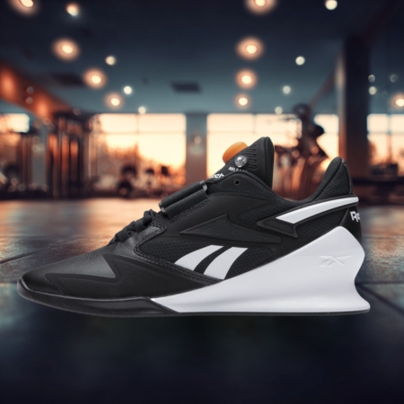 Black and white Reebok Legacy Lifter III weightlifting shoe with an elevated heel, displayed in a gym setting