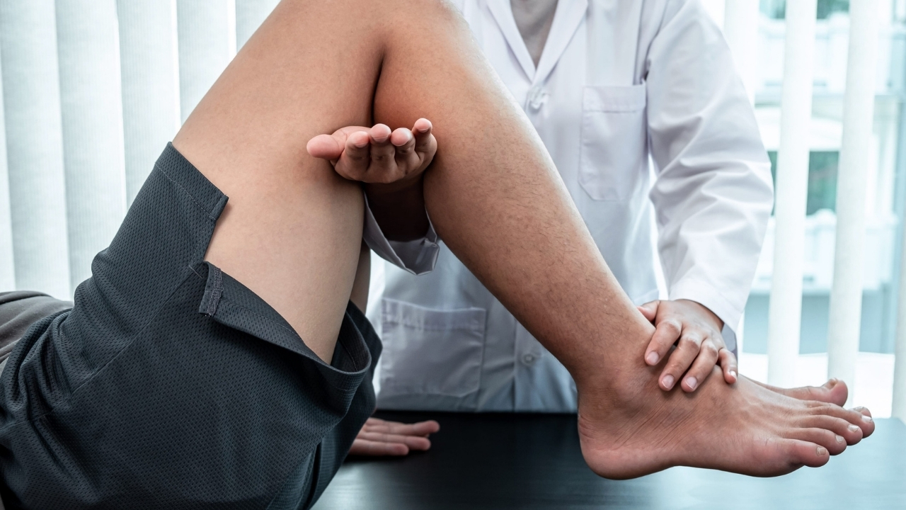 Doctor checks a patient's knee during an orthopedic exam